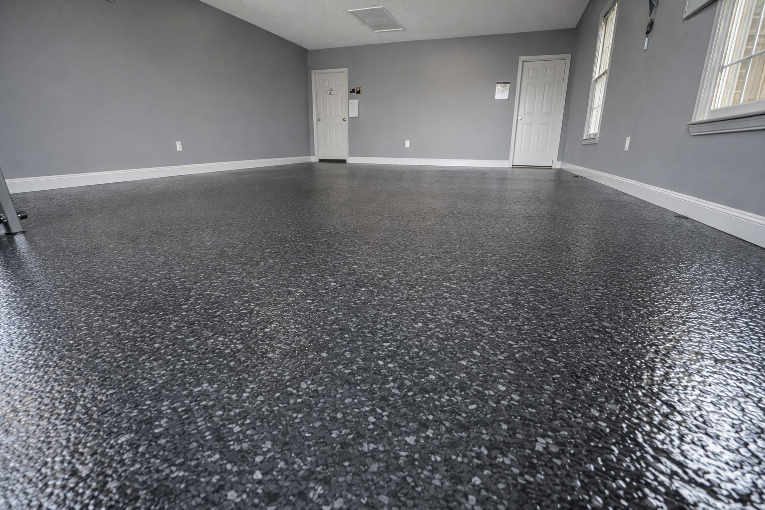 Finished flake epoxy garage floor with a clean gray finish