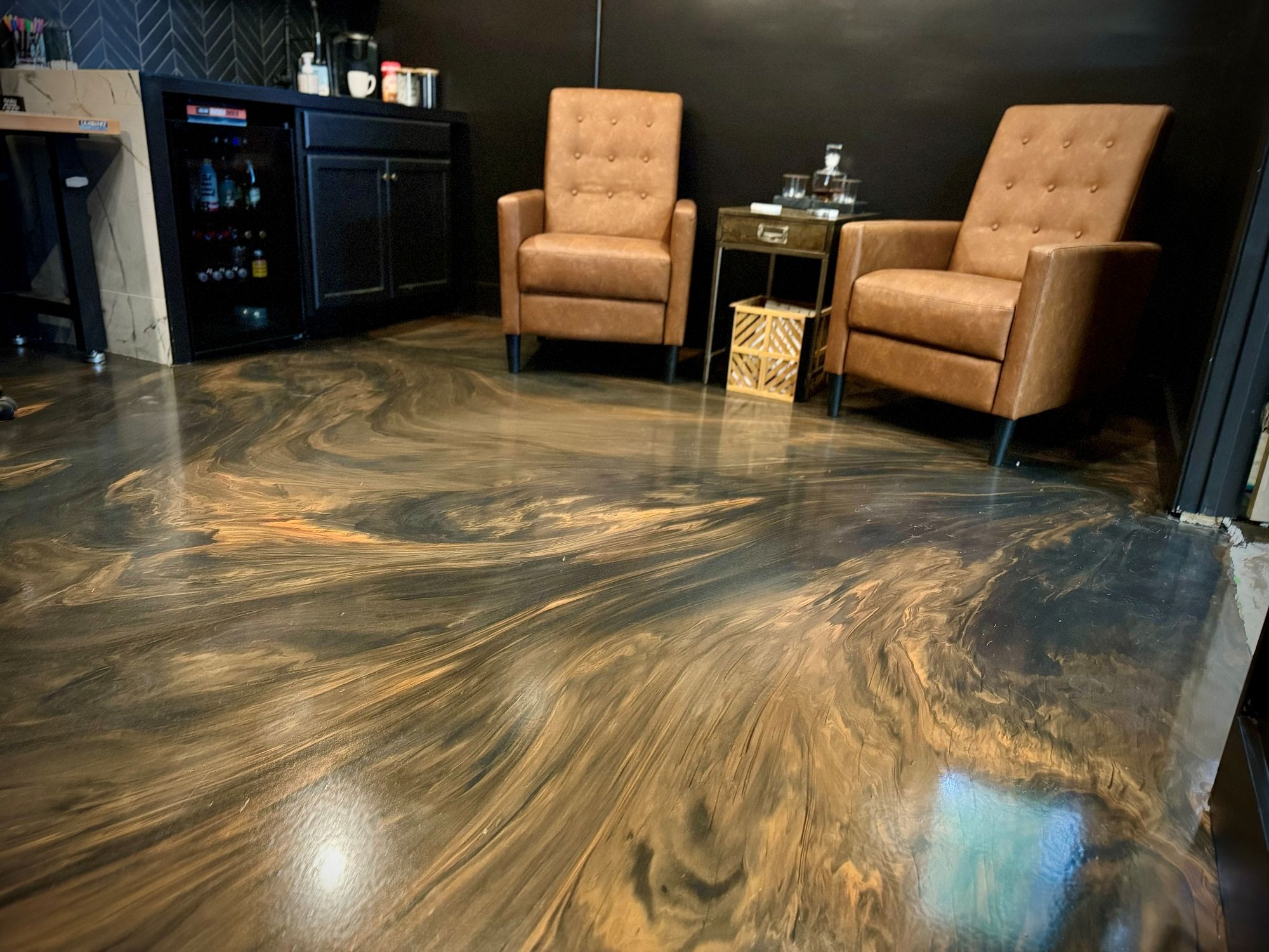 Bronze and black metallic epoxy floor in a finished office lounge