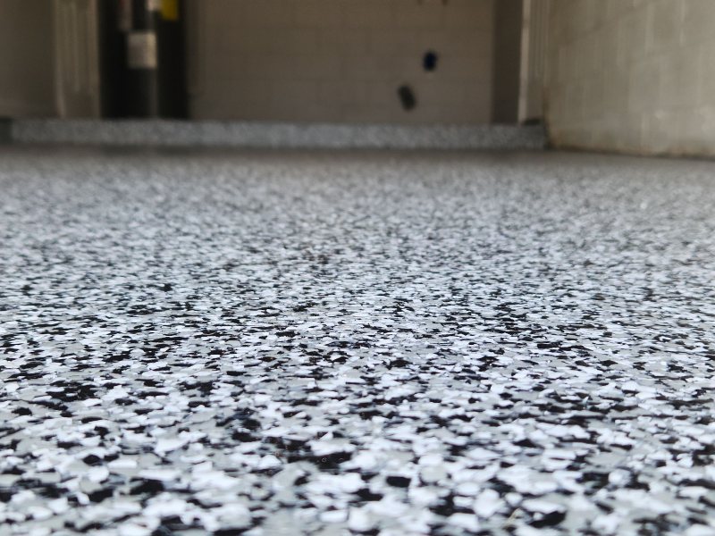 Tuxedo flake epoxy garage floor with a clean speckled finish