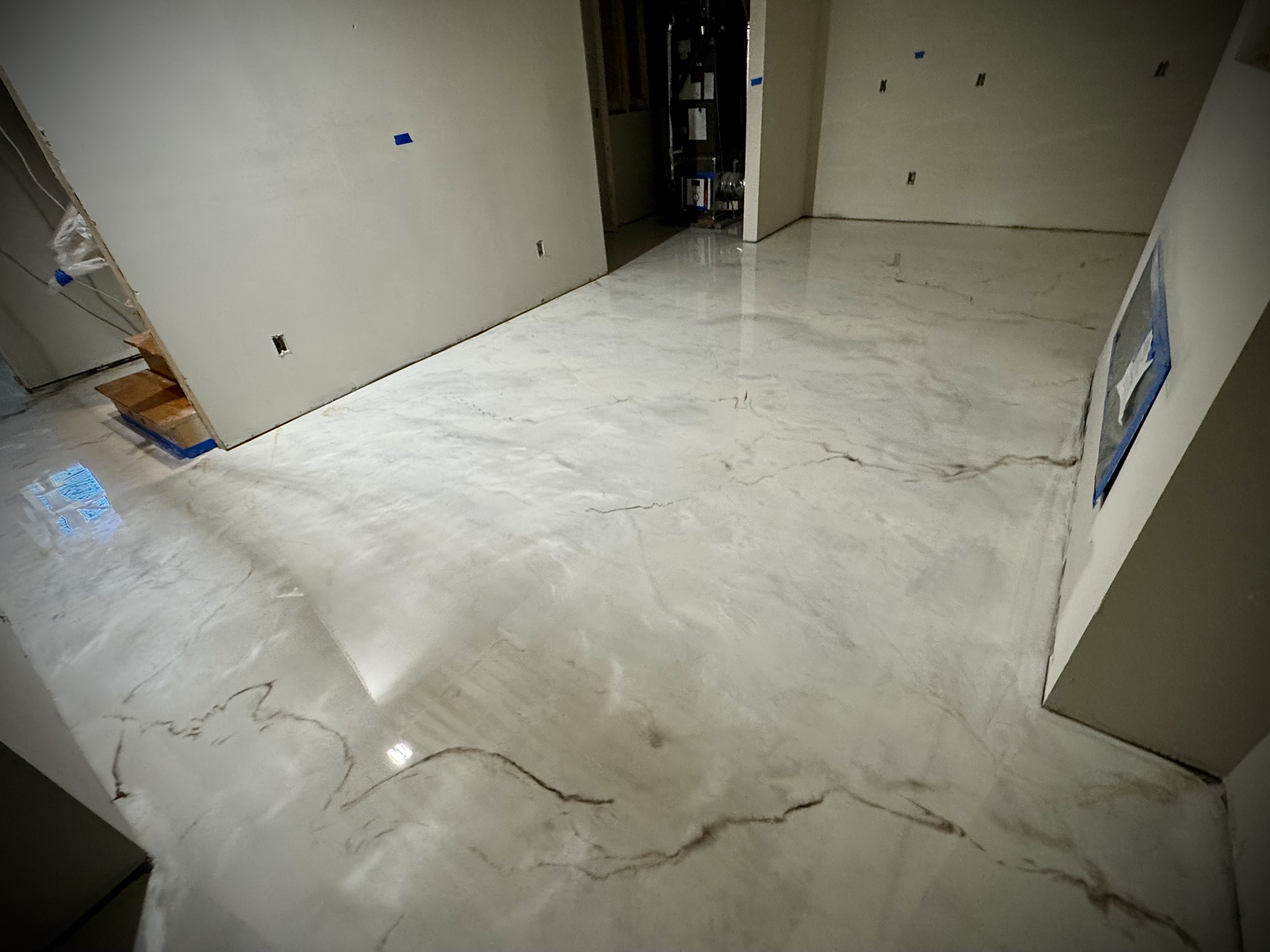 White metallic epoxy basement floor with marble-style movement