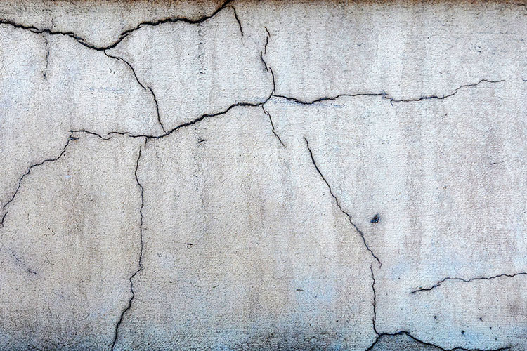 Cracked concrete slab being assessed before epoxy flooring in Boone, NC