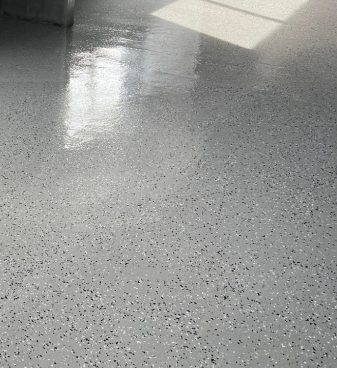 Finished gray flake epoxy floor ready for final walkthrough