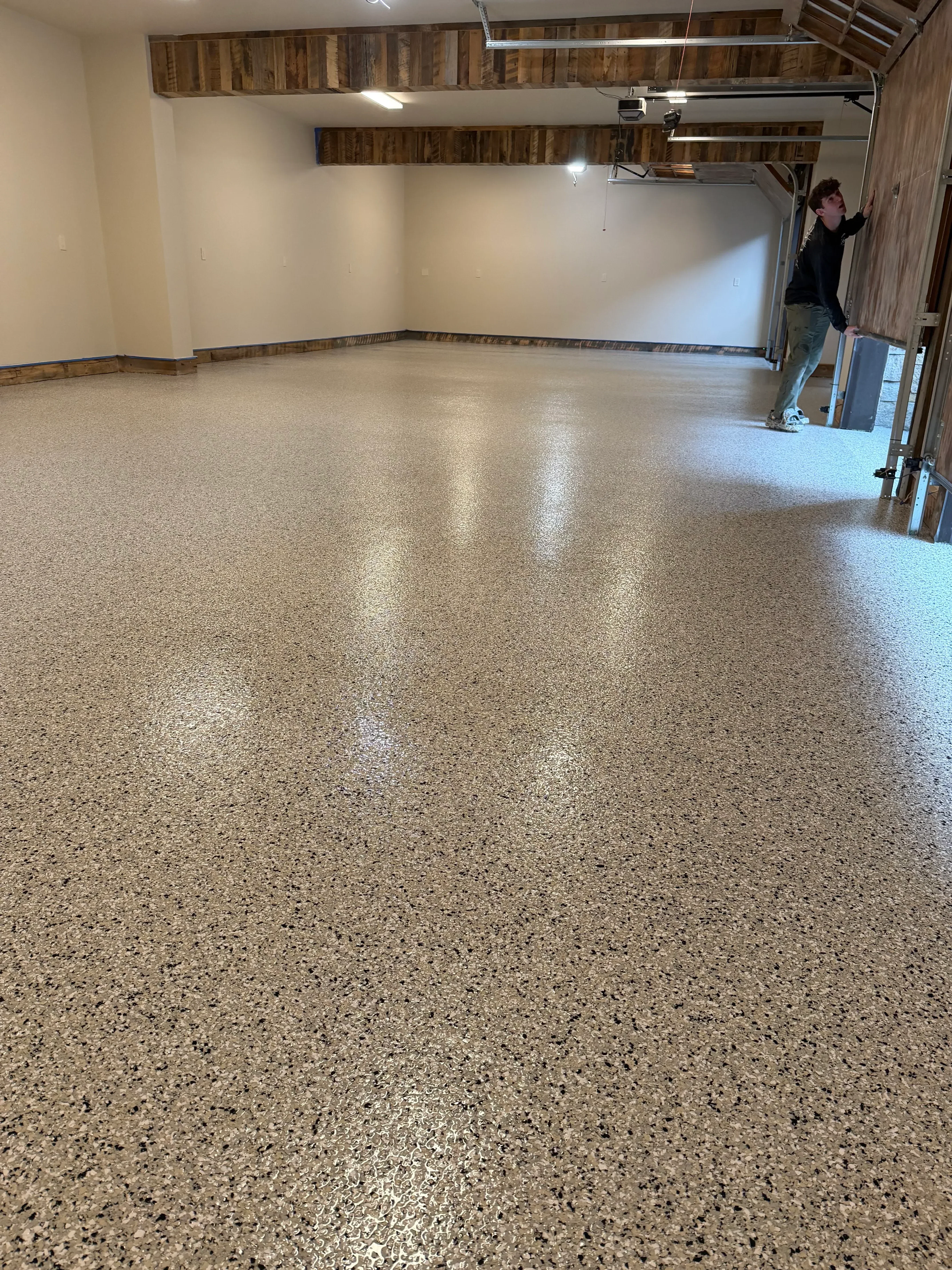 Polished concrete floor with light gray aggregate finish and professional sheen in large open space