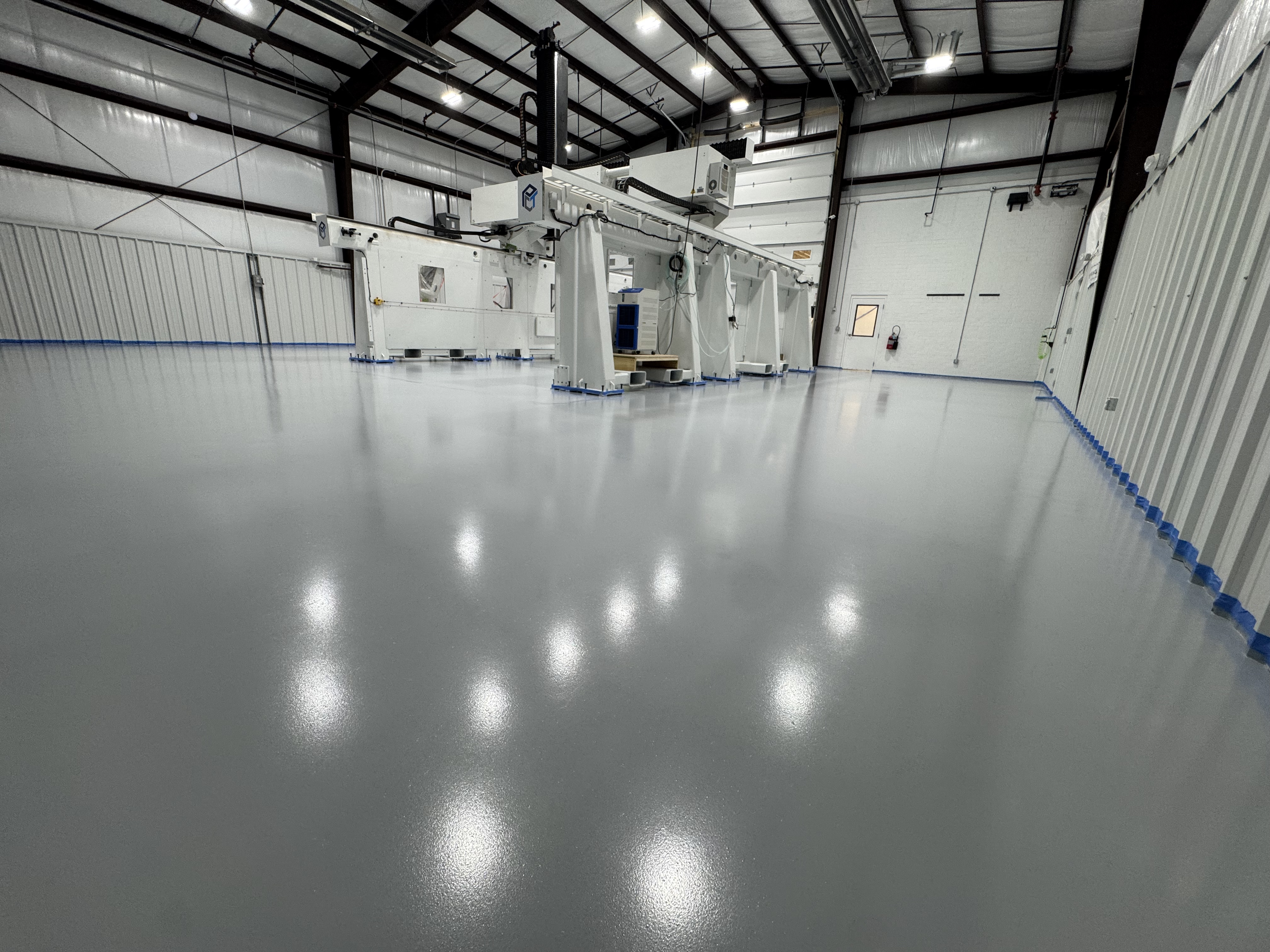 Gray commercial epoxy floor coating in an industrial warehouse