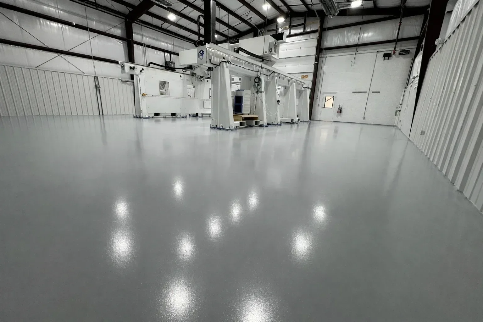 A polished concrete floor inside a residential space in Boone, NC, showing a smooth, light-reflective surface with a consistent sheen. The floor has been ground and refined to a clean finish with no coatings or overlays on top of the existing slab.