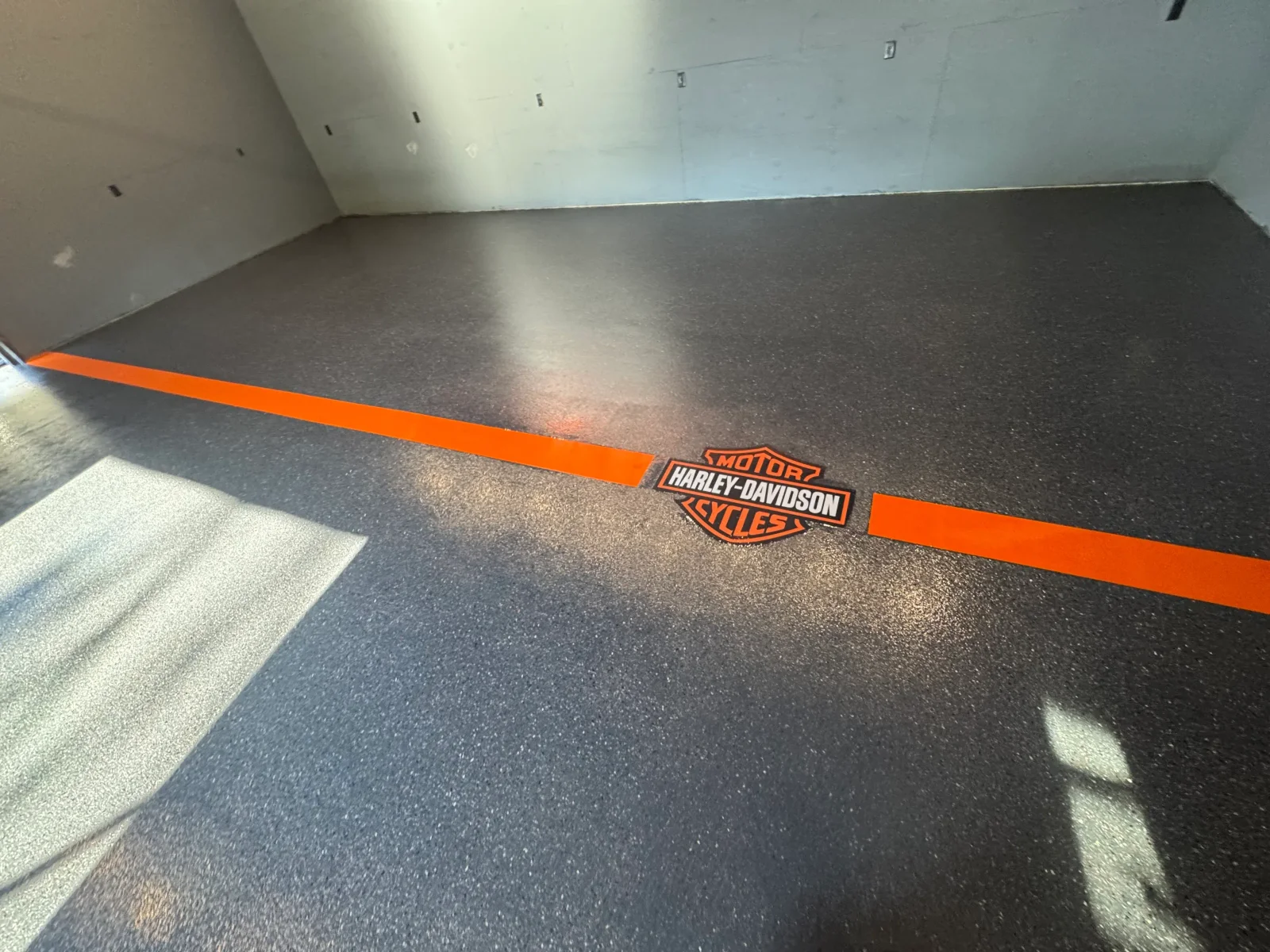 Finished quartz epoxy garage floor in a Boone, NC home showing a textured, slip-resistant surface with a clean, polished appearance. The quartz aggregate finish reflects light evenly across the sealed concrete slab.